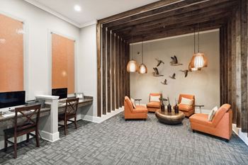 a living room with couches and chairs and a desk at The Loree, Jacksonville, 32256